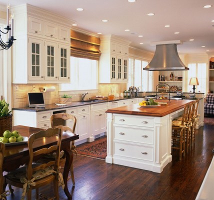 Kitchen island with wood countertop contrasts beautifully (Craft Maid)