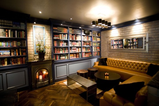A home library with a fireplace.