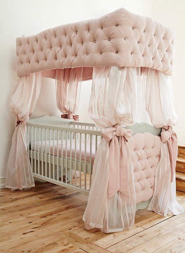 A pink cot in a baby's room.