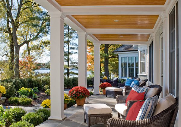 A front porch with wicker furniture and a view of the water.