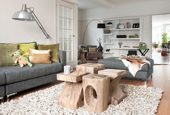 A living room with a grey couch and alternative coffee table options.