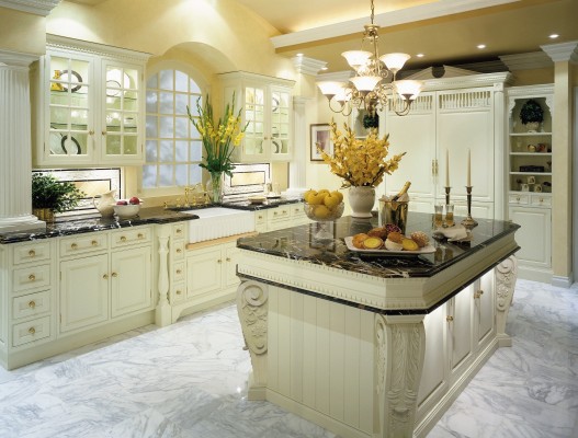 A traditional kitchen with marble counter tops.