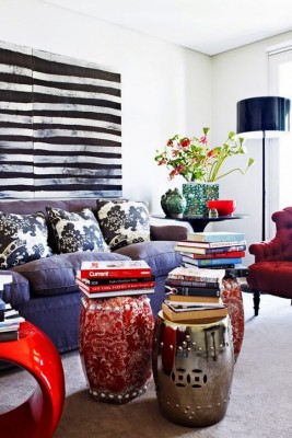 A living room with red couch and chairs, offering unique coffee table alternatives.