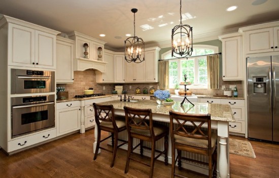 A traditional kitchen with a center island and bar stools.