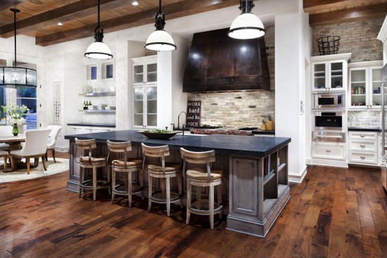 A spacious kitchen featuring wood floors and a central island.