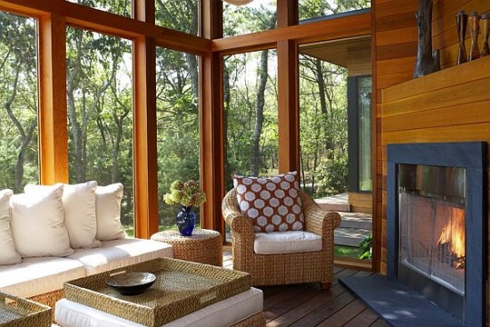 A beautiful wooded view enhances this sunroom (Homedit)