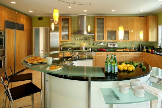 A kitchen with a curved counter top on an island.