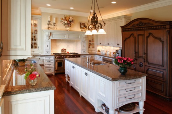 A traditional kitchen with white cabinets and a center island.