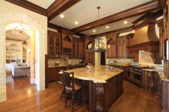 A traditional kitchen with wooden cabinets and a center island.