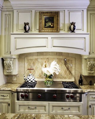 A traditional kitchen with a rooster on top of the stove.