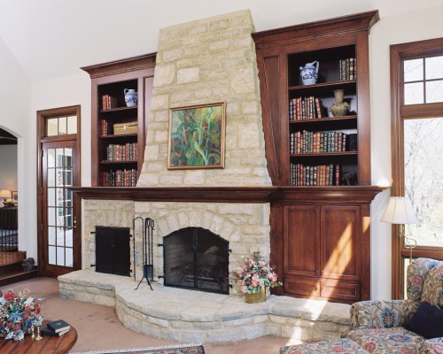 A cozy fireplace in a home library.
