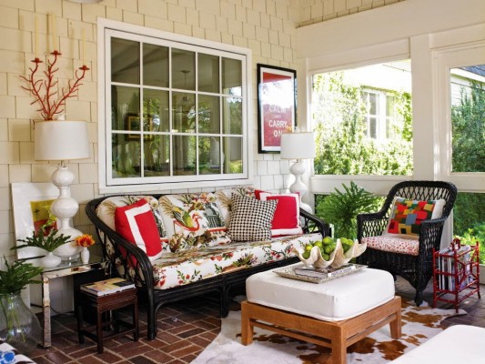 A front porch with wicker furniture.