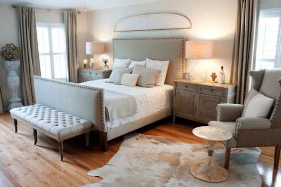 Styling a bedroom with a bed and a cowhide rug.