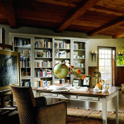 A home library with a desk and bookshelves.