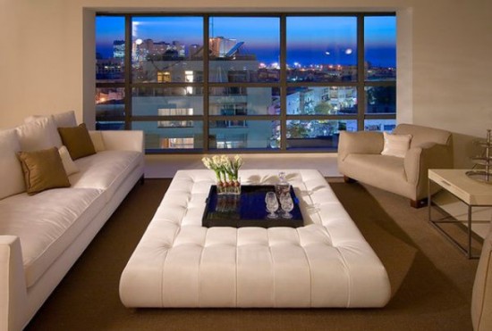 A white living room with alternative coffee table options and a view of the city.