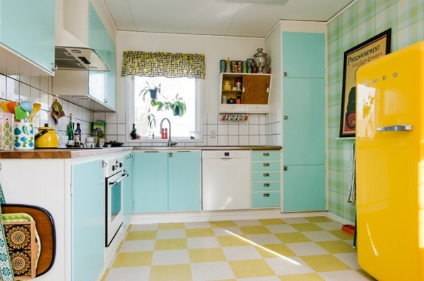 A vintage yellow and blue kitchen with a checkered floor.