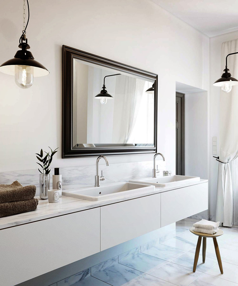 An eccentric white bathroom with two sinks and a mirror.