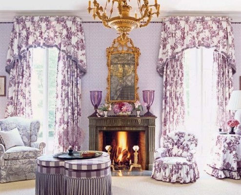 A living room with purple curtains and a fireplace.
