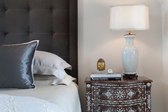 A bedroom with a bed and a stylish nightstand for choosing.