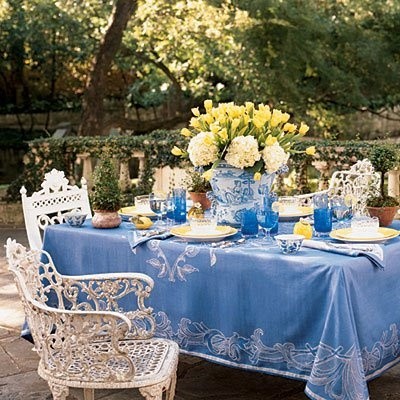 A backyard dining table setting in blue and white.