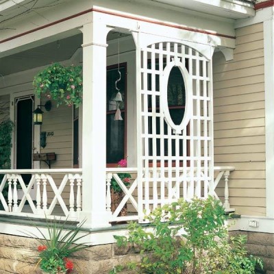 A white front porch with a wooden railing.