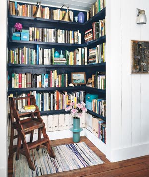 A home library corner with bookshelves and a chair.