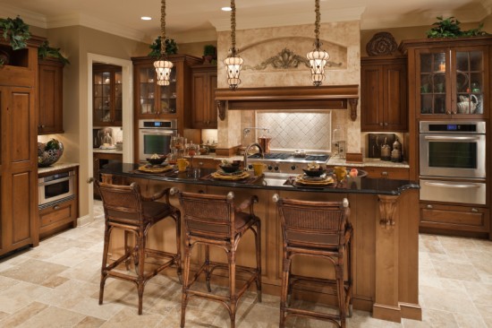 A traditional kitchen with brown cabinets and a center island.