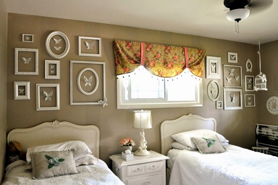 A bedroom with two picture frames on the wall.