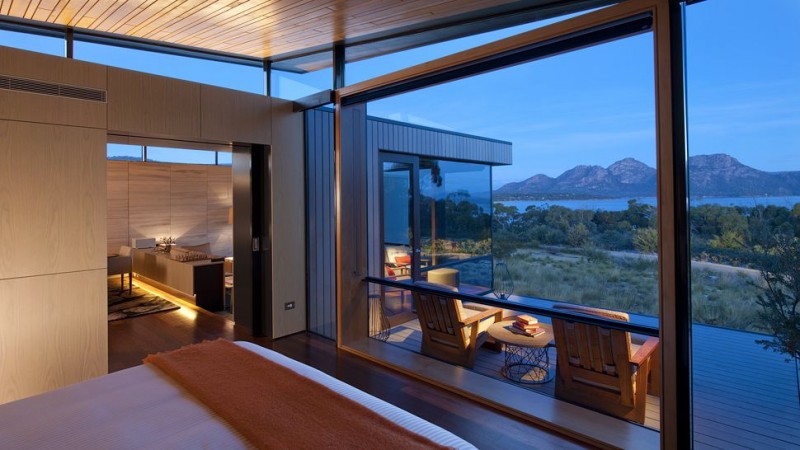 suite-bedroom-large-windows-patio-mountain-view-dusk