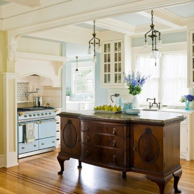 A kitchen with a wooden island and a blue stove.