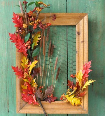 A picture frame filled with fall leaves.