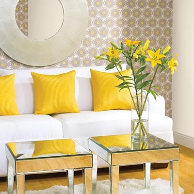 A living room with a yellow couch and white coffee table showcasing the basics of interior design.