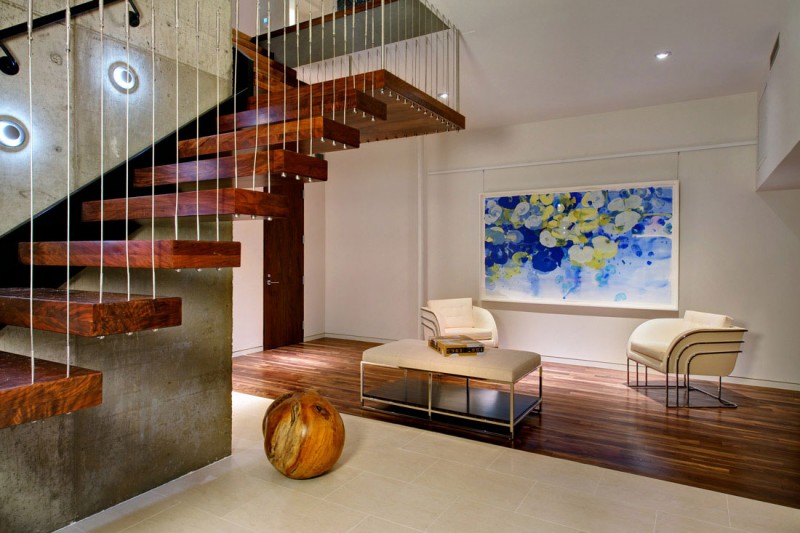 A living room featuring a wooden floor and staircase, showcasing the use of natural wood in your home.