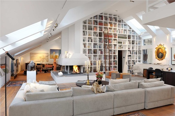 An attic loft space filled with bookshelves.