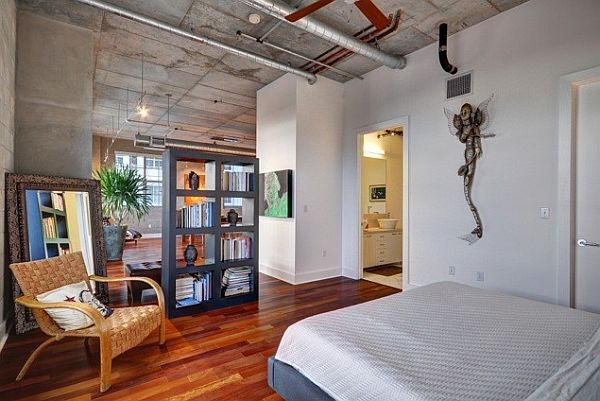 A loft space with wood floors and a bed.