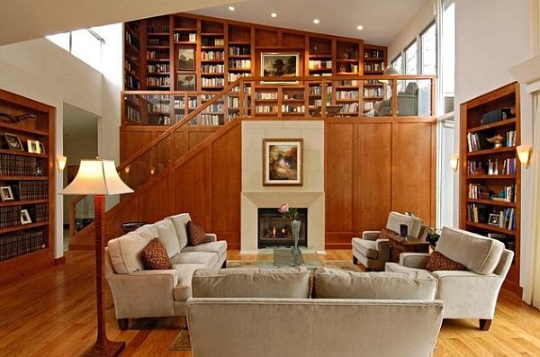 A loft space featuring a living room with a fireplace and bookshelves.