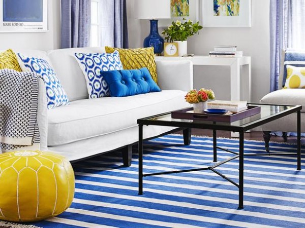 A bright yellow pouf adds a fresh update to this interior 