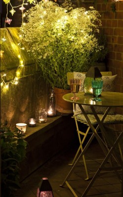 String lights and candles add a romantic touch to the balcony 