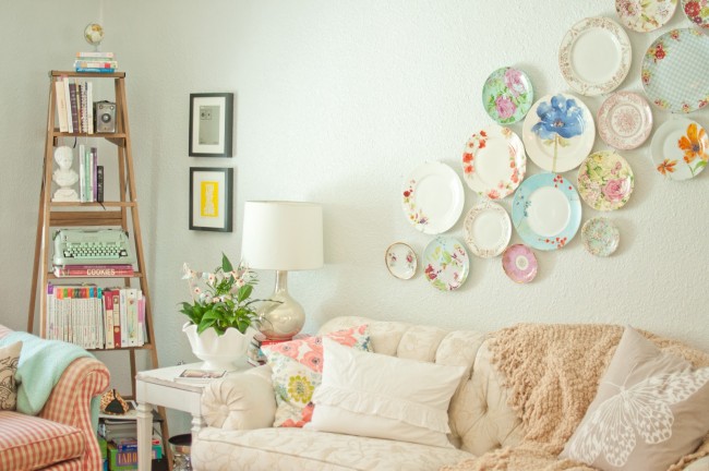 A pretty plate display above the sofa