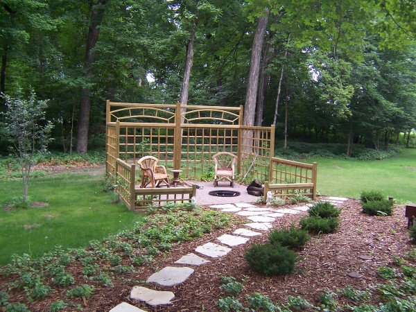 A wooden swing set in a grassy area perfect for backyard entertainment.