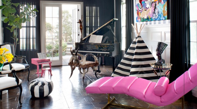 A whimsical pink chair in a living room.