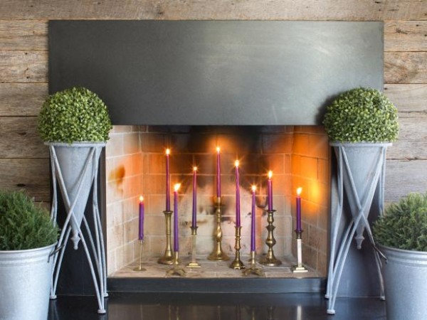 A beautiful display of candles accents this off-season fireplace