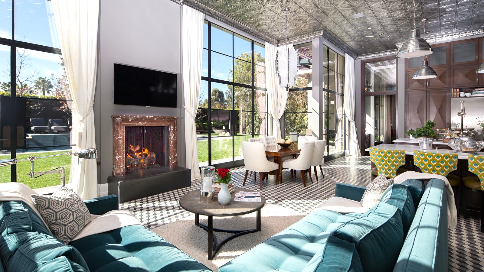 A living room incorporating the basics of interior design, including large windows and a fireplace.
