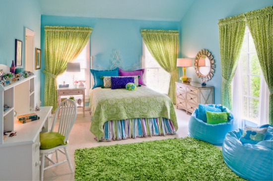 A girl's blue and green bedroom with a green rug.