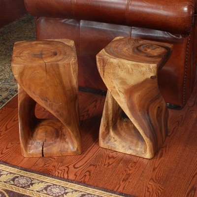 Two natural wooden stools in a living room.