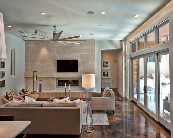 A living room with basic interior design featuring a ceiling fan and sliding glass doors.