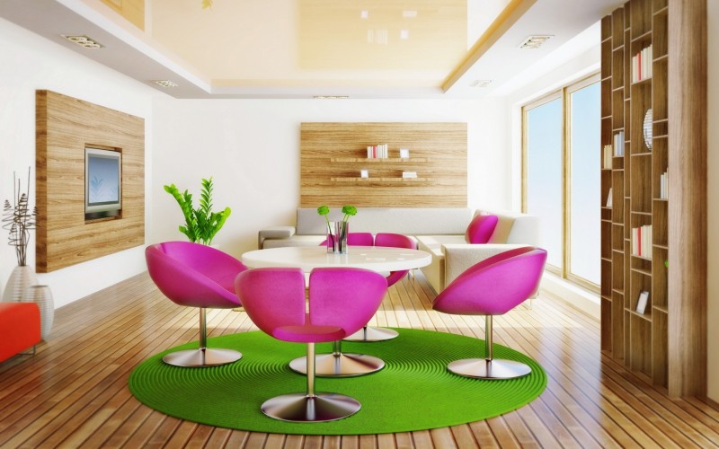 A living room with pink chairs and a natural wooden floor.