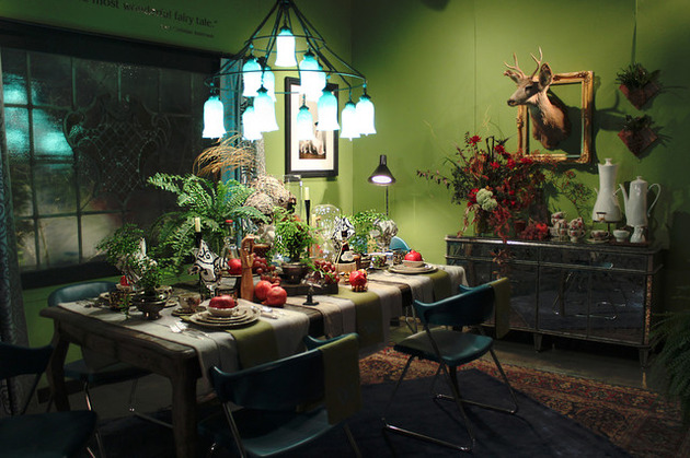 A whimsical dining room with a green table and chairs.