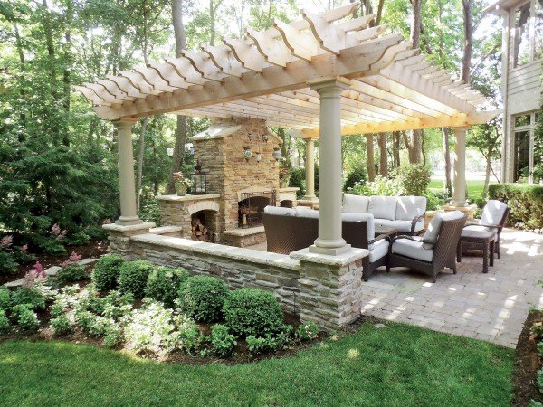 Stonework accents this pergola for an outdoor seating area