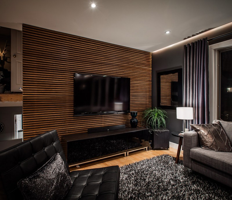A living room with a tv on the wall decorated using natural wood in your home.